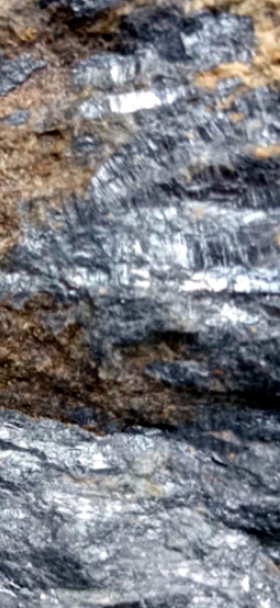 Detail of bladed antimony crystals with iron staining