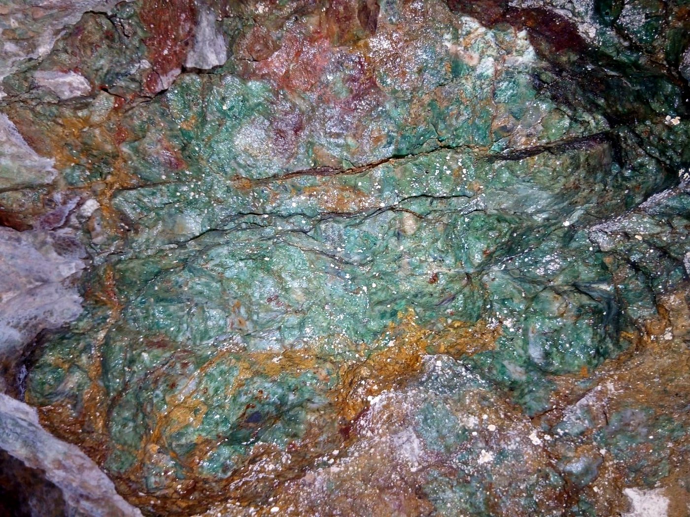 Close-up of high-grade copper ore with vivid green malachite and blue azurite banding across the rock face