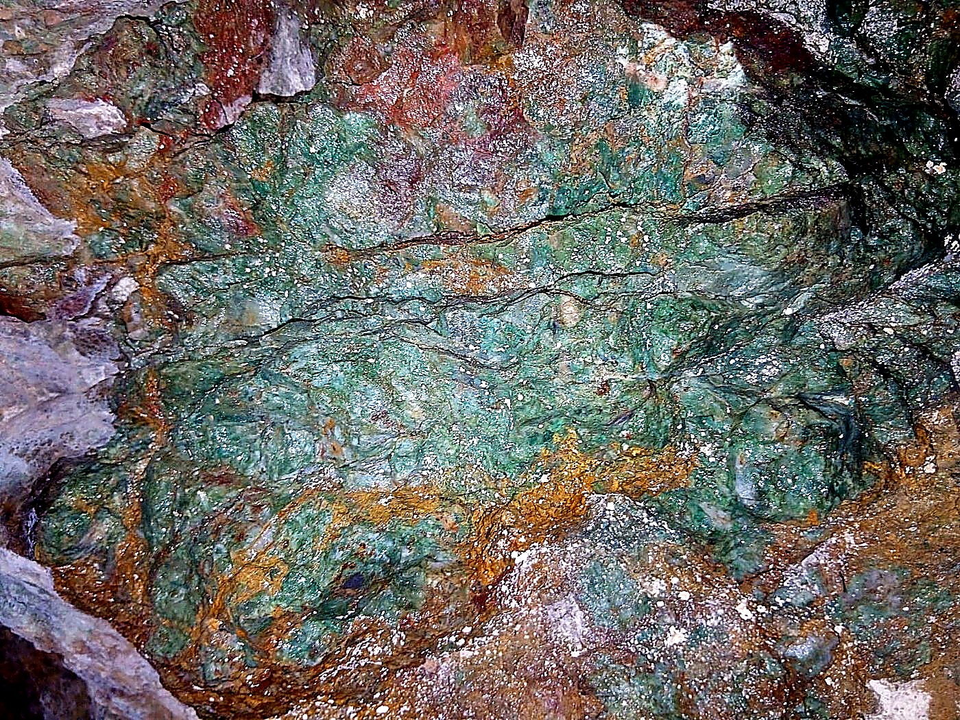 Close-up of high-grade copper ore with vivid green malachite and blue azurite banding across the rock face